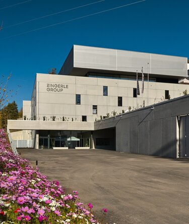 Zingerle Group headquarters in Sciaves, South Tyrol, surrounded by forest and mountains.